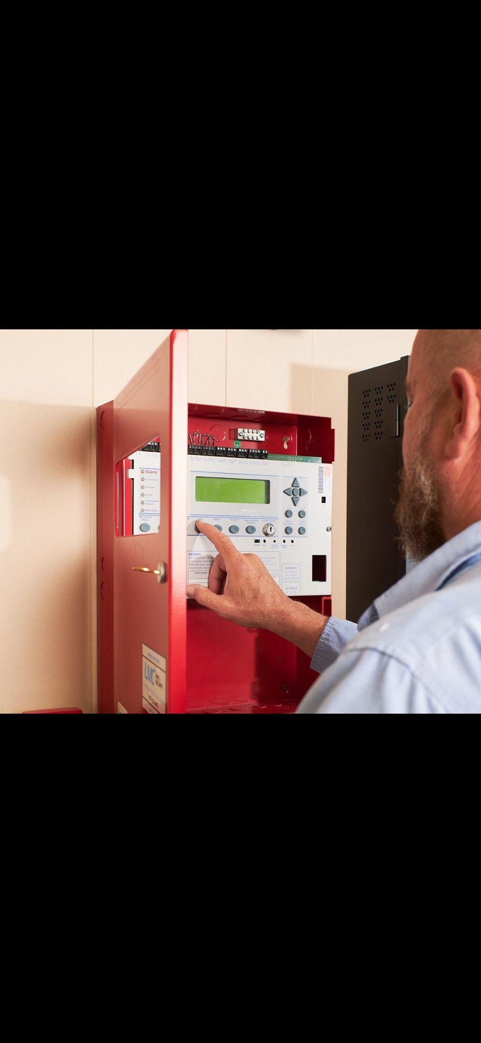 Engineer programming fire alarm control panel